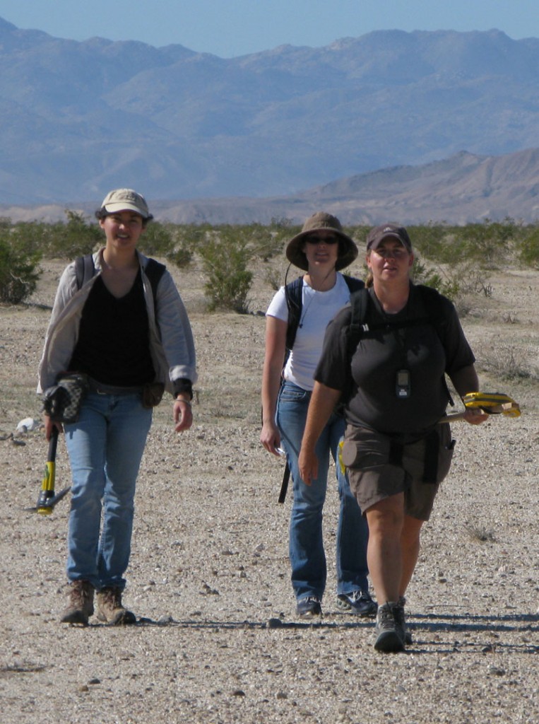 Figure 5. Backpacking seismographs across a Naval bombing range. Each person is carrying about 8 Texan seismographs and deployment equipment.