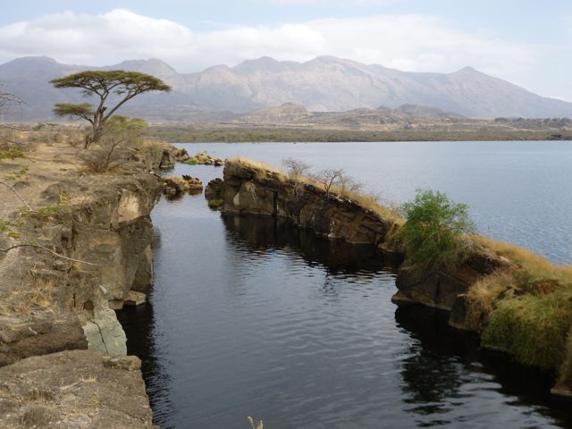 Figure 2. A fissure on the edge of Lake Besaka. Fantale volcano is in the background; it last erupted 170,000 years ago.